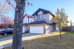 View of front of home with driveway and an attached garage - 