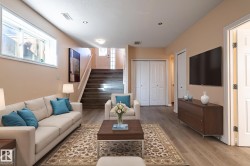 Living area featuring stairway and light wood-style flooring - 