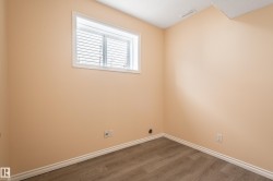Empty room featuring wood finished floors and baseboards - 