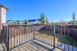 Gate featuring a fenced backyard, a residential view, and a balcony - 