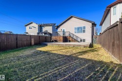 Rear view of property with a deck, a fenced backyard, and stairs - 