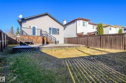 Back of property featuring a deck, a fenced backyard, and stairway - 