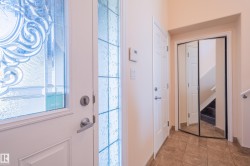 Doorway with tile patterned floors and stairway - 
