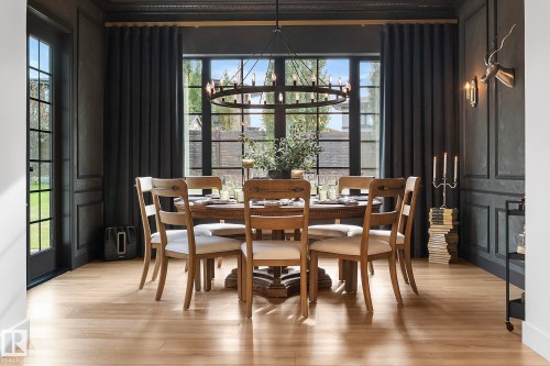 Dining area with a chandelier and light wood-style floors - 183 Windermere Drive, Edmonton, AB - Indoor Photo Showing Dining Room