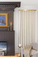 Living area featuring wood finished floors and a large fireplace - 
