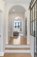 Corridor featuring wood finished floors, a chandelier, and recessed lighting - 