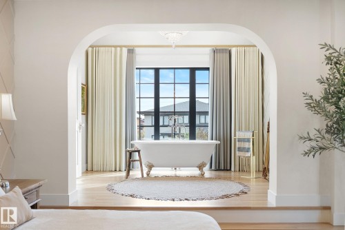 Bedroom featuring arched walkways and wood finished floors - 183 Windermere Drive, Edmonton, AB - Indoor