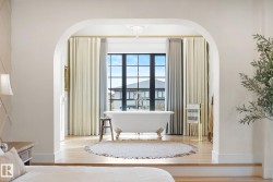Bedroom featuring arched walkways and wood finished floors - 
