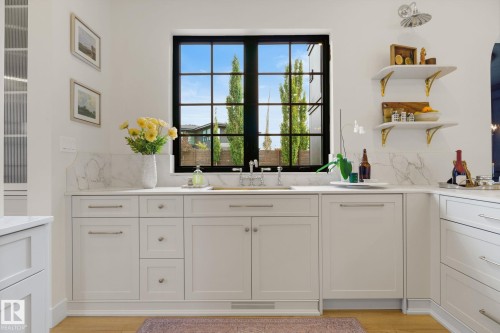 Kitchen with white cabinets, backsplash, and open shelves - 183 Windermere Drive, Edmonton, AB - Indoor