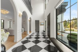 Hallway featuring a chandelier and arched walkways - 