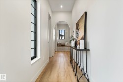 Corridor with light wood finished floors and arched walkways - 