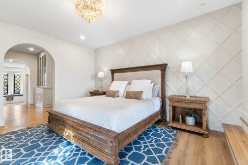 Bedroom with wood finished floors, an accent wall, arched walkways, and recessed lighting - 183 Windermere Drive, Edmonton, AB - Indoor Photo Showing Bedroom