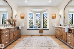 Full bath featuring two vanities, light wood-type flooring, and recessed lighting - 