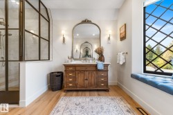 Bathroom with vanity, light wood finished floors, and a stall shower - 