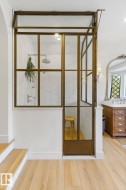 Doorway featuring wood finished floors and baseboards - 