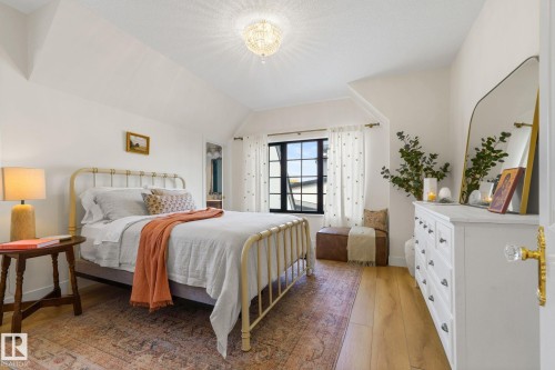 Bedroom featuring light wood-type flooring, vaulted ceiling, and a chandelier - 183 Windermere Drive, Edmonton, AB - Indoor Photo Showing Bedroom