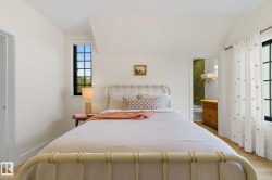 Bedroom with ensuite bath and light wood-style flooring - 