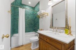 Bathroom with shower / bathtub combination with curtain, vanity, and light wood-style flooring - 