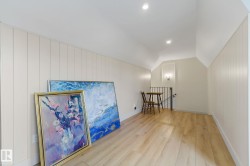 Bonus room with wood finished floors, vaulted ceiling, wood walls, and recessed lighting - 