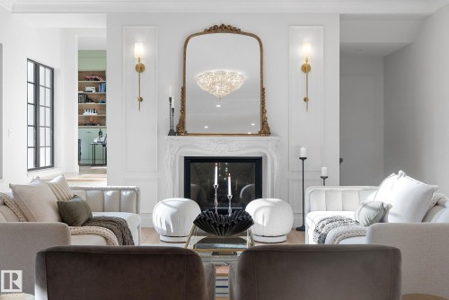 Living room featuring a premium fireplace, a chandelier, and wood finished floors - 183 Windermere Drive, Edmonton, AB - Indoor Photo Showing Living Room With Fireplace