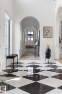 Hallway featuring arched walkways and a high ceiling - 