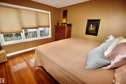 Bedroom featuring wood finished floors and a textured ceiling - 13910 101A Avenue, Edmonton, AB - Indoor Photo Showing Bedroom
