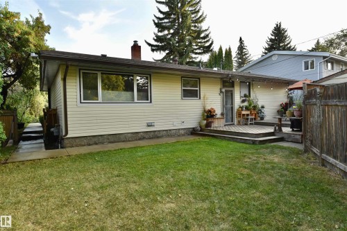 Back of property with a chimney and a wooden deck - 13910 101A Avenue, Edmonton, AB - Outdoor With Deck Patio Veranda With Exterior