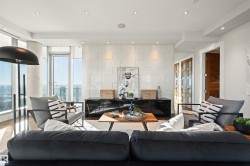 Living area with recessed lighting and expansive windows - 