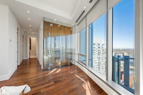 Spare room featuring dark wood-type flooring, recessed lighting, a wall of windows, and a view of city - 3201 11969 Jasper Avenue, Edmonton, AB - Indoor Photo Showing Other Room