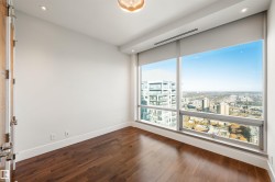 Unfurnished room with recessed lighting, a city view, and dark wood-style floors - 