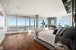 Bedroom featuring dark wood finished floors, multiple windows, recessed lighting, and a city view - 