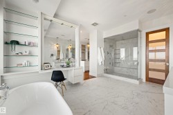 Full bathroom featuring vanity, light marble finish flooring, a soaking tub, a marble finish shower, and recessed lighting - 