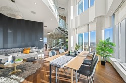 Lobby featuring recessed lighting, stairs, wallpapered walls, and a towering ceiling - 