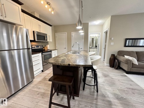 218 508 Griesbach Parade, Edmonton, AB - Indoor Photo Showing Kitchen With Stainless Steel Kitchen With Double Sink With Upgraded Kitchen