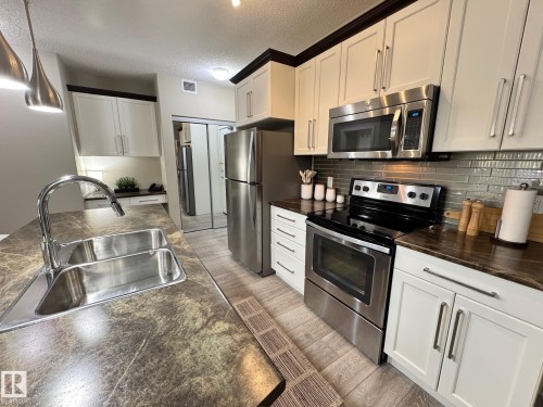 218 508 Griesbach Parade, Edmonton, AB - Indoor Photo Showing Kitchen With Stainless Steel Kitchen With Double Sink With Upgraded Kitchen