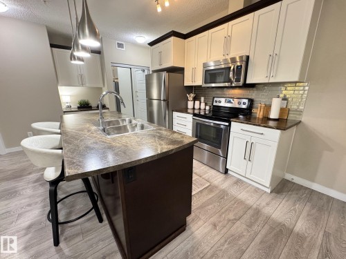 218 508 Griesbach Parade, Edmonton, AB - Indoor Photo Showing Kitchen With Stainless Steel Kitchen With Double Sink With Upgraded Kitchen