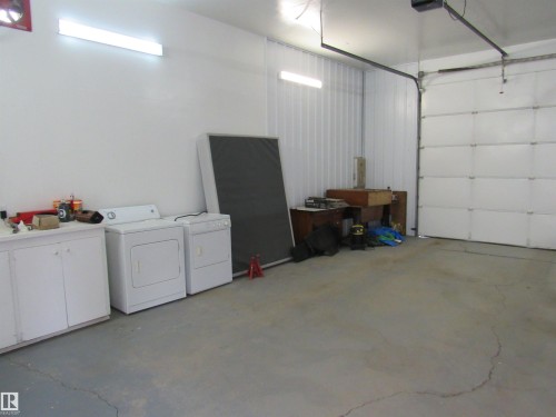 Garage featuring separate washer and dryer - 5016 51 Street, Barrhead, AB - Indoor Photo Showing Garage
