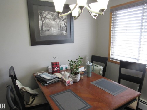 Dining space with a chandelier, a desk, and plenty of natural light - 5016 51 Street, Barrhead, AB - Indoor Photo Showing Office