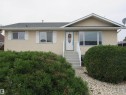 View of front facade featuring stucco siding and entry steps - 5016 51 Street, Barrhead, AB  - Outdoor 