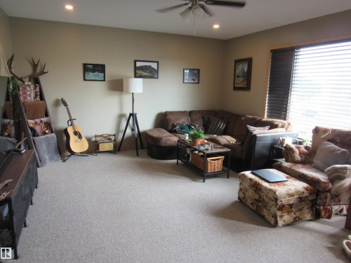 Living area featuring carpet floors, recessed lighting, and a ceiling fan - 5016 51 Street, Barrhead, AB - Indoor Photo Showing Living Room