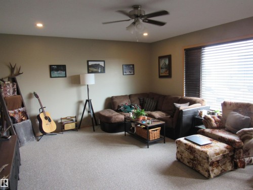 Living room with carpet floors, ceiling fan, and recessed lighting - 5016 51 Street, Barrhead, AB - Indoor Photo Showing Living Room