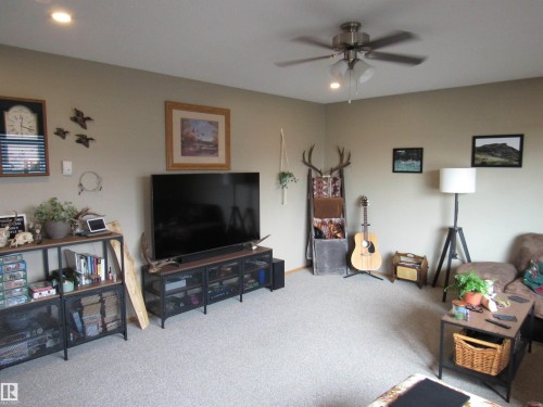Living area featuring carpet flooring, ceiling fan, and recessed lighting - 5016 51 Street, Barrhead, AB - Indoor Photo Showing Living Room