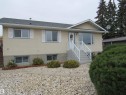 View of front facade with stucco siding and a shingled roof - 5016 51 Street, Barrhead, AB  - Outdoor With Facade 
