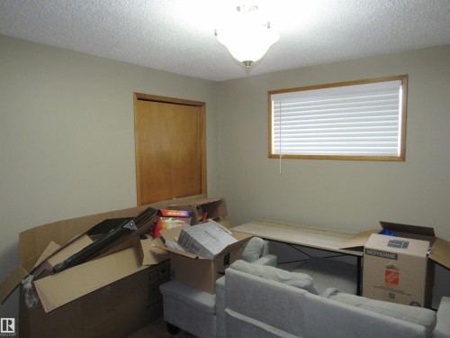 Bedroom with a textured ceiling - 5016 51 Street, Barrhead, AB - Indoor