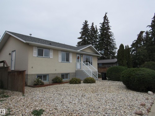 Ranch-style home featuring stucco siding and roof with shingles - 5016 51 Street, Barrhead, AB - Outdoor