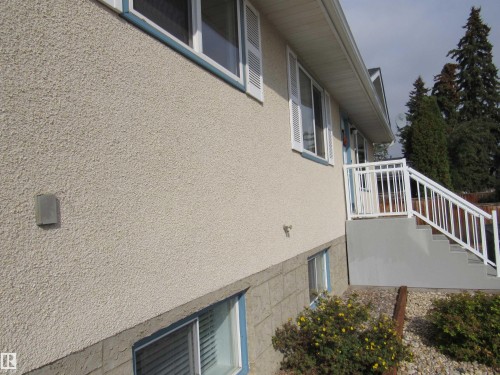 View of home's exterior featuring stucco siding - 5016 51 Street, Barrhead, AB - Outdoor With Exterior