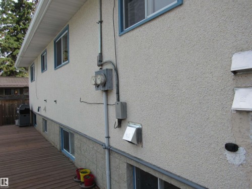 Exterior view of stucco siding and electric meter - 5016 51 Street, Barrhead, AB - Outdoor With Exterior