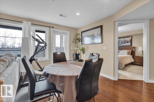 Dining space featuring a textured ceiling, wood finished floors, and recessed lighting - 305 5029 Edgemont Boulevard, Edmonton, AB - Indoor Photo Showing Dining Room
