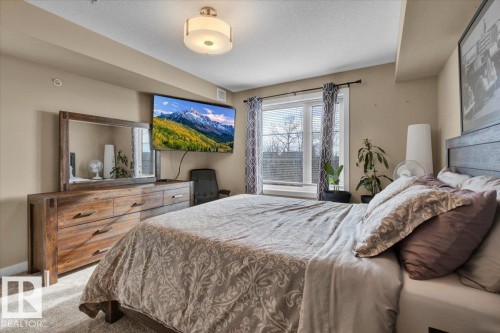 Bedroom featuring carpet and a textured ceiling - 305 5029 Edgemont Boulevard, Edmonton, AB - Indoor Photo Showing Bedroom