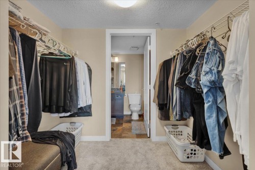 Walk in closet with light carpet - 305 5029 Edgemont Boulevard, Edmonton, AB - Indoor With Storage